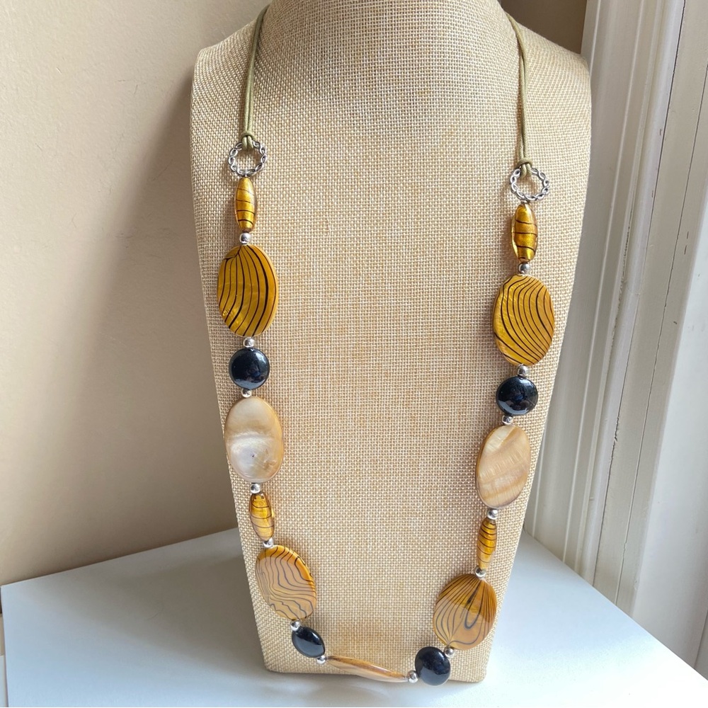 Long glass and dyed shell beaded necklace in tan, striped golden brown and black